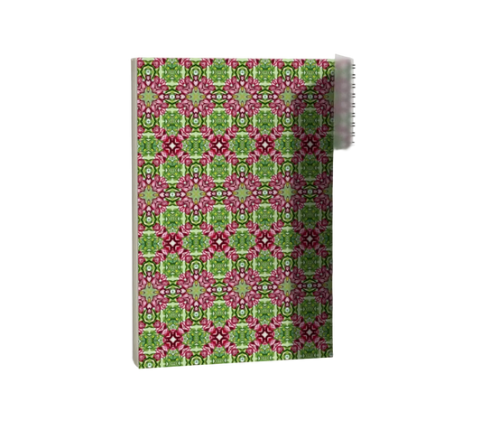 Notebook with pink and green geometric pattern on a white background