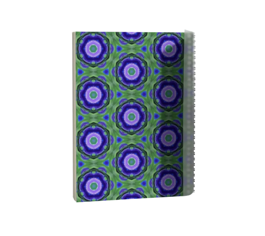 Notebook with a green and purple geometric pattern on a white background