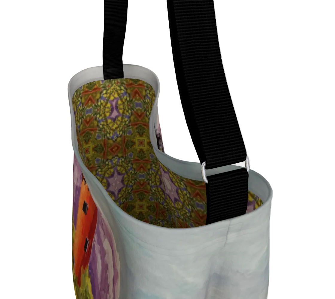 Colorful bag with floral pattern and black strap on a white background