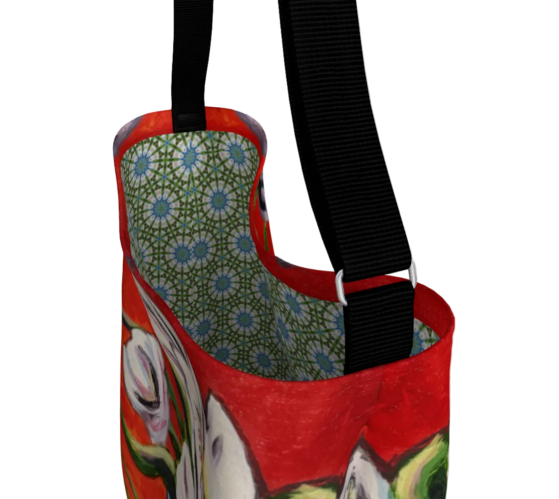 Red bag with floral pattern and black strap on a white background