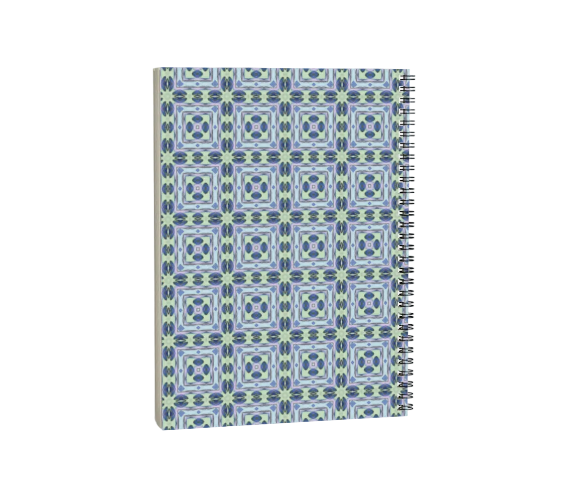 Notebook with a blue and green geometric pattern on a white background