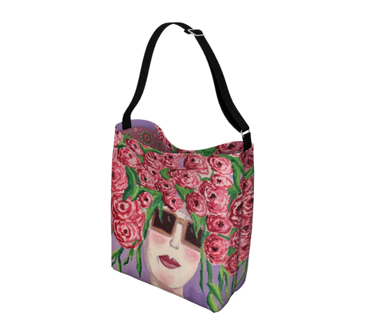Tote bag with floral design and face on a white background